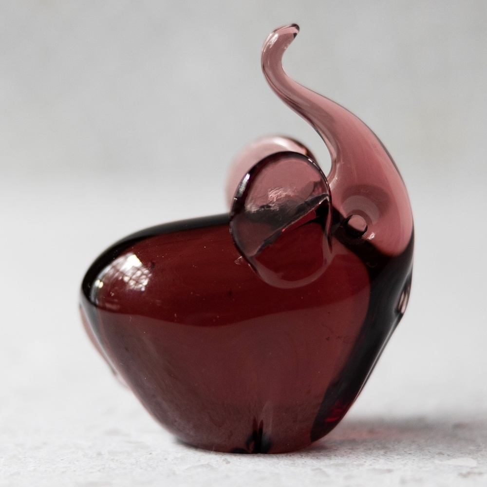 Purple glass elephant figurine with trunk curled up unknown maker 3.5" x 2.75"
